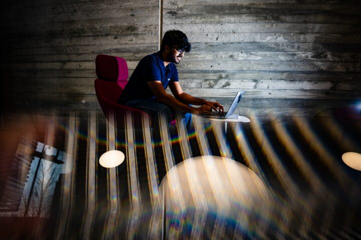 Student working on project on their laptop in a quiet setting