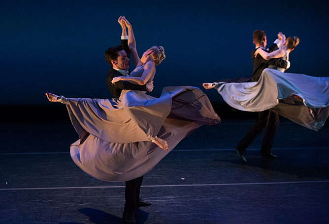 Performing-arts students in costume dancing on a stage.