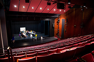 Theater students performing on a stage.