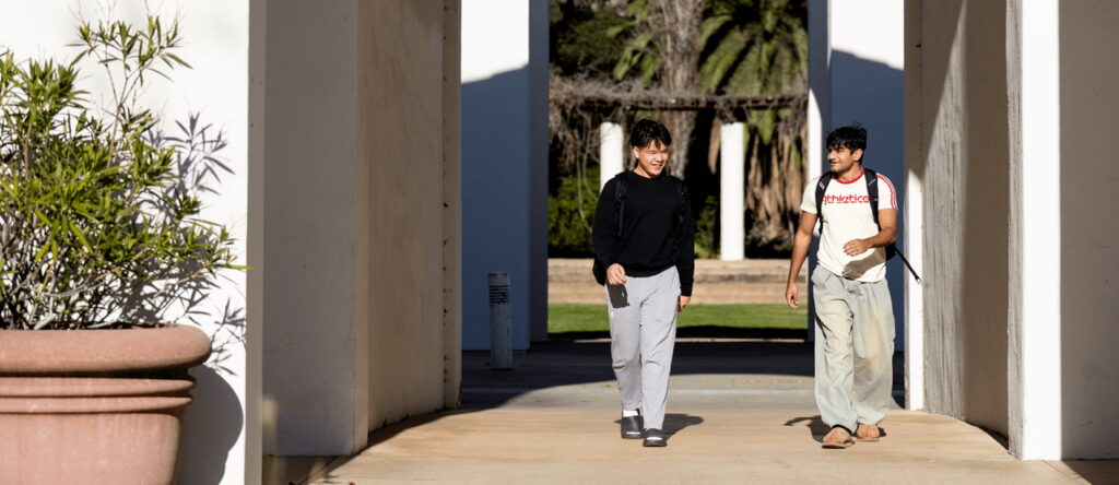 Two students walking on campus
