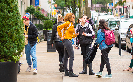 Students walking outdoors in New York City.